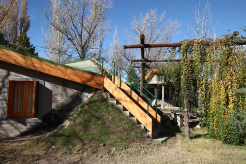 a wooden staircase leading to a house with a fence at La Pilar Petit Chalets in San Rafael