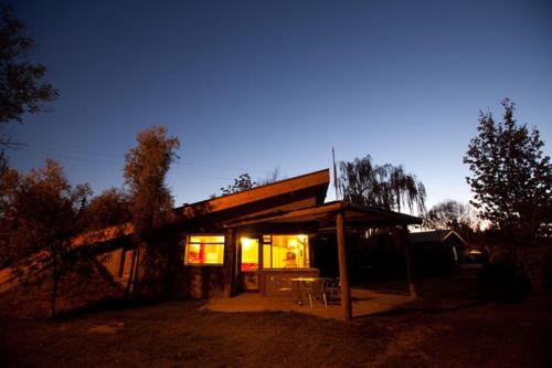 a small house with lights on in the yard at La Pilar Petit Chalets in San Rafael