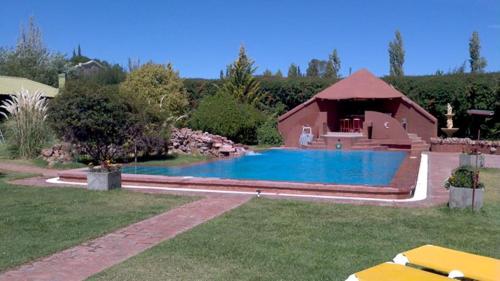 a swimming pool in a yard with a house at La Pilar Petit Chalets in San Rafael