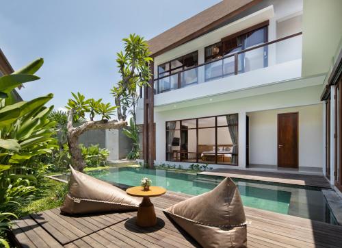 an image of a villa with a swimming pool at Agrapana Beach Villa in Gianyar
