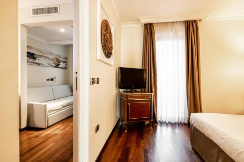Postel nebo postele na pokoji v ubytování Trilussa Palace Hotel Congress & Spa