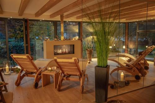 a living room with chairs and a fireplace at SALZANO Hotel - Spa - Restaurant in Interlaken