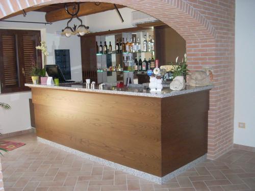 a bar in a room with a brick wall at Agriturismo La Rosa Montefalco in Montefalco