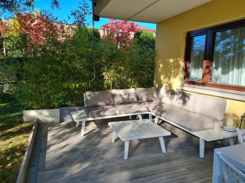 a patio with a couch and a coffee table at Gabi's Wolfühloase in Balerna