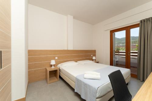 Ένα ή περισσότερα κρεβάτια σε δωμάτιο στο Hotel Delfino
