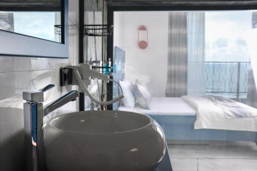 a bathroom with a sink and a bed at Blue Ay Boutique Hotel in Atakum