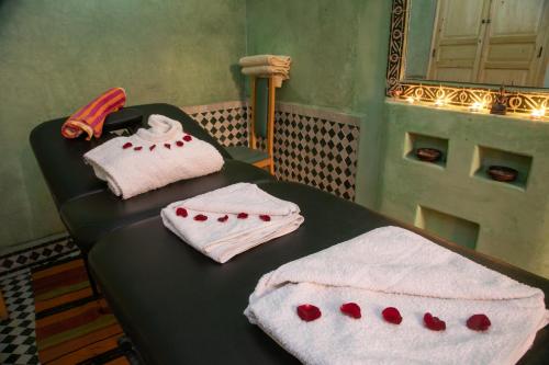 two towels on a table in a room at Riad Losra in Marrakesh