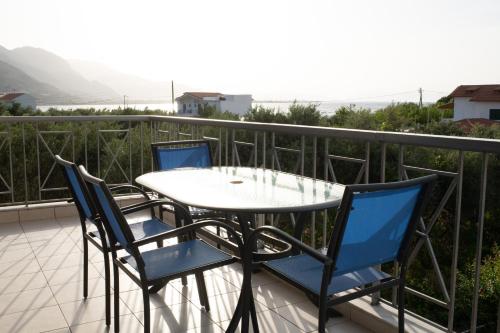 a table and chairs on a balcony with a view at Punda 4 Seasons in Diakopto
