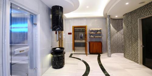a hallway with a walk in shower and a mirror at Crowne Plaza Bursa Convention Center & Thermal Spa by IHG in Bursa