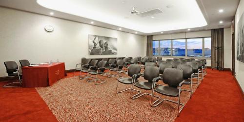a conference room with a row of chairs and a podium at Crowne Plaza Bursa Convention Center & Thermal Spa by IHG in Bursa