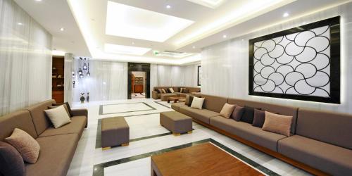 a living room with a couch and chairs and a table at Crowne Plaza Bursa Convention Center & Thermal Spa by IHG in Bursa