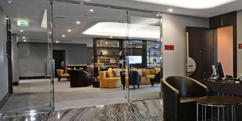a lobby with a bar with couches and chairs at Crowne Plaza Bursa Convention Center & Thermal Spa by IHG in Bursa