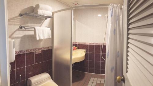 a small bathroom with a toilet and a sink at SUN 9 Inn in Hengchun South Gate