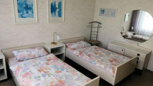 a bedroom with two beds and a mirror at Comfortable apartment for 2 Persons in Hannover