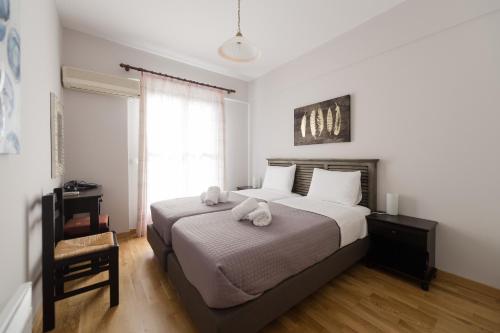 a bedroom with a bed with two stuffed animals on it at Punda 4 Seasons in Diakopto