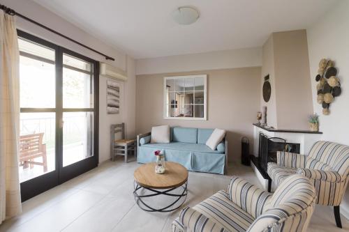 a living room with a blue couch and chairs at Punda 4 Seasons in Diakopto
