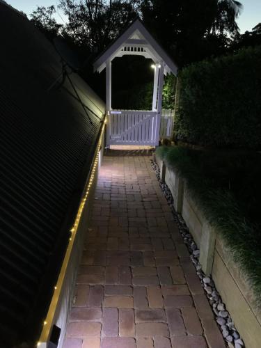 a walkway with a gazebo at night at Mountain Studio Escape in Mount Tamborine