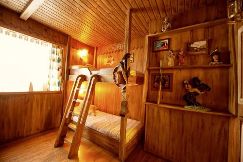 a room with a bunk bed and a ladder in a cabin at Suites Plaza Hotel & Wellness in Andorra la Vella