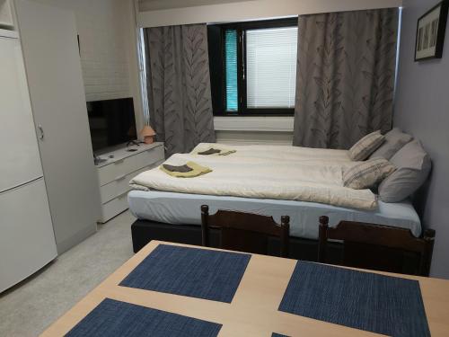מיטה או מיטות בחדר ב-Ruskalinna Apartments