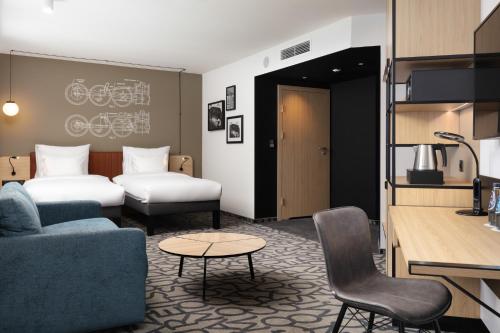 a hotel room with a couch and a bed at Mercure Warszawa Ursus Station in Warsaw