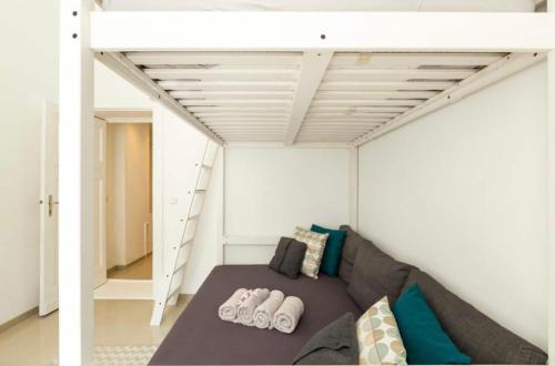 a room with a couch and a loft bed at Nice City Center Studio in Berlin