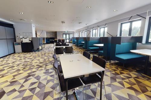 a dining room with tables and chairs at Village Hotel Coventry in Coventry