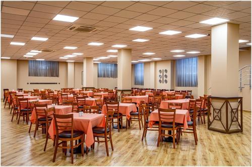 a dining room with tables and chairs in it at Ani Grand Hotel Yerevan in Yerevan