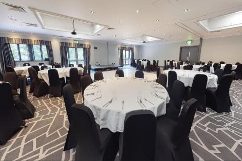 a conference room with tables and chairs in it at Village Hotel Coventry in Coventry