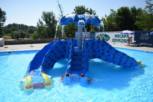 a water slide in a swimming pool at Etno Selo Moravski Konaci in Velika Plana