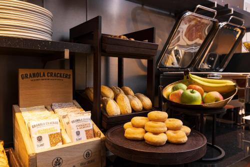 a display of food on a table in a bakery at Huygens Place Amsterdam in Amsterdam