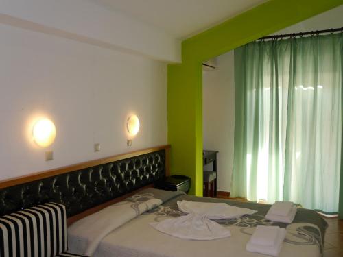 a bedroom with a bed and a green wall at Blue Sky Villas in Skala Potamias