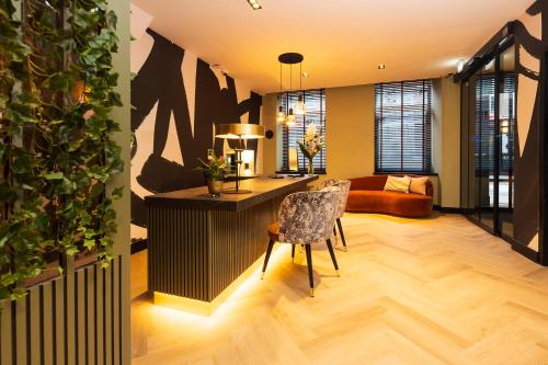 a living room with a table and a chair and a couch at Huygens Place Amsterdam in Amsterdam