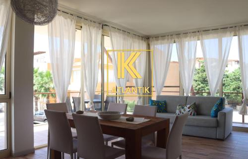 a dining room with a table and a couch at KatlantiK Ca Madeira Deluxe in Sal Rei