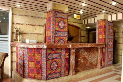 a counter with colorful blankets on it in a room at Sea Star in Alexandria