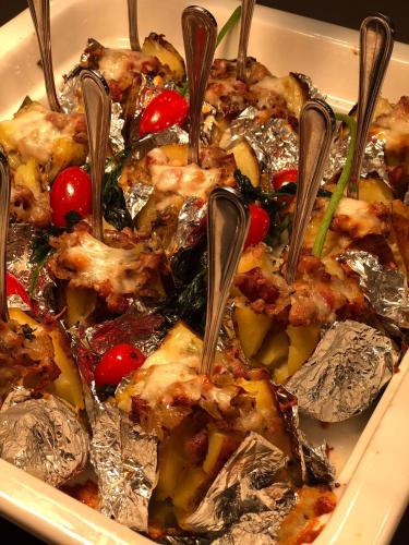 a dish of food with tongs in it at HVD Club Bor Ultra All Inclusive - Private Beach & Free parking in Sunny Beach