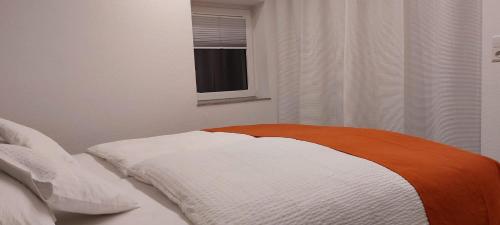 a bed in a bedroom with a window at Am Meilenstein in Limburg an der Lahn