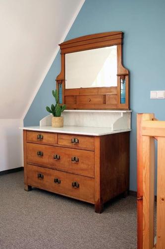 a dresser with a mirror on top of it at Ferienhaus Schloßblick in Quedlinburg