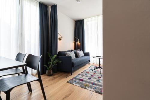 a living room with a couch and a table at Omaela Apartments in Sankt Anton am Arlberg