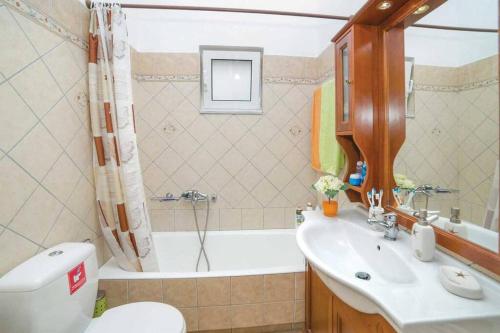 a bathroom with a toilet and a sink and a tub at Villa Anastasia Chania in Daratso