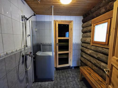a bathroom with a shower and a toilet and a window at Mäntyaho in Syöte
