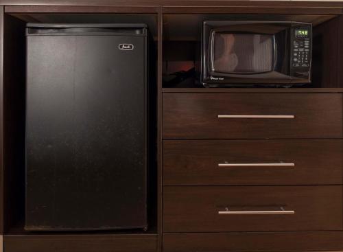 a kitchen with a refrigerator and a microwave at Baymont Inn & Suites by Wyndham Lincoln NE in Lincoln