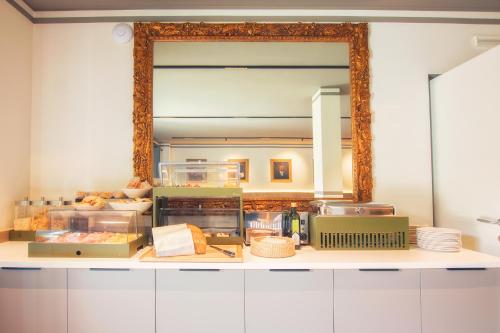 a large mirror above a counter in a kitchen at Hotel Residence Dolcenero in San Daniele del Friuli