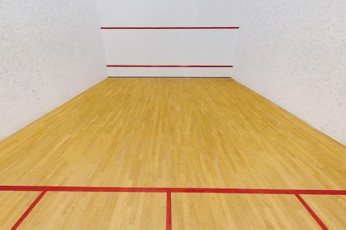 an empty gymnasium with a wooden basketball court at Village Hotel Wirral in Bromborough