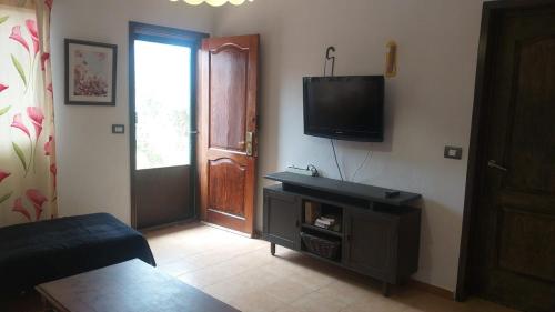 a living room with a flat screen tv on the wall at Cottage near the mountains away from crowd in Las Palmas de Gran Canaria