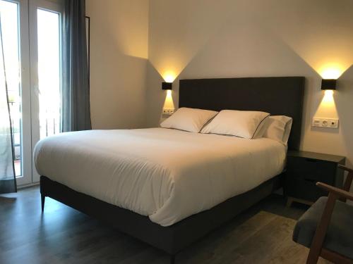 Posteľ alebo postele v izbe v ubytovaní Apartamentos Ciudad de Ronda