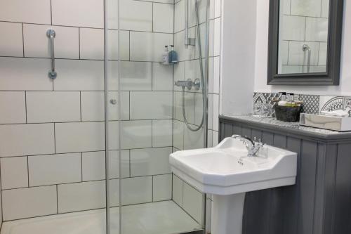 a white sink sitting under a mirror in a bathroom at Lansdown Grove Hotel in Bath