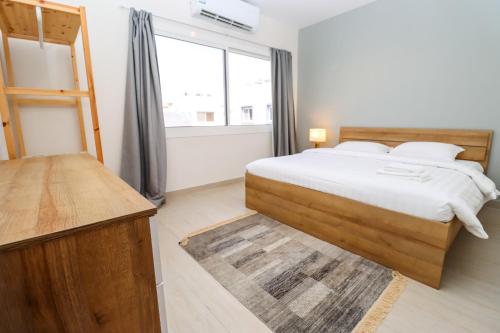 a bedroom with a bed and a ladder and a window at Mabaat - White Pearl Al Basatin - 600 in Jeddah