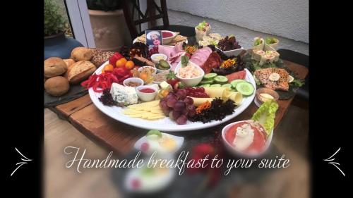 a table with a plate of food on a table at Paul's Fantasia Boutique Suites in Szczecin