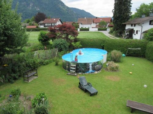 a person in a pool in a yard at Steffl Martina in Grassau