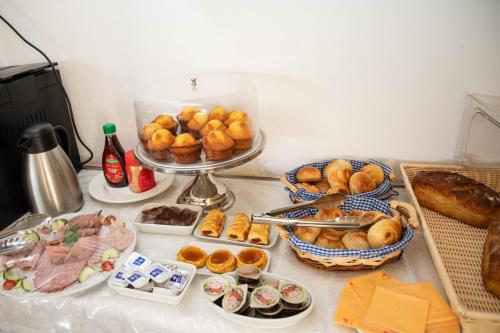 a table topped with plates of food and pastries at A-Z Boutique Guesthouse in Windhoek